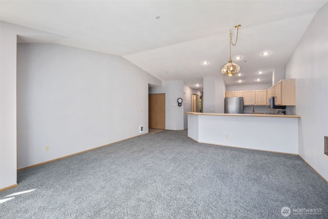 11325 19th Ave SE Unit C309, Everett, WA 98208 - unfurnished living room featuring carpet flooring, vaulted ceiling, baseboards, a chandelier, and recessed lighting