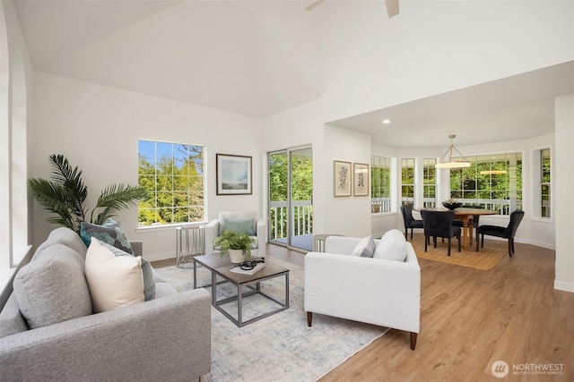 8021 NE Sandpiper Ln, Bainbridge Island, WA 98110 - living area with baseboards, light wood finished floors, healthy amount of natural light, and recessed lighting
