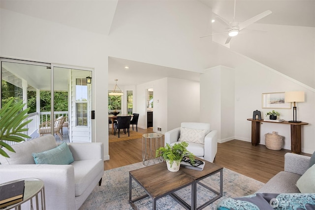 8021 NE Sandpiper Ln, Bainbridge Island, WA 98110 - living area with wood finished floors, baseboards, high vaulted ceiling, and a ceiling fan