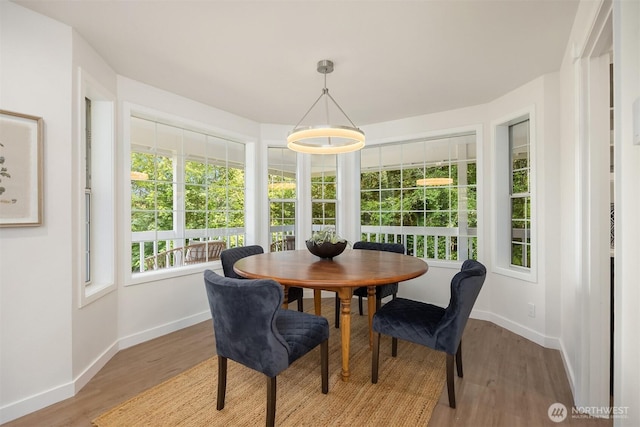 8021 NE Sandpiper Ln, Bainbridge Island, WA 98110 - dining space featuring baseboards and light wood-style floors