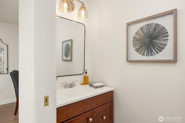 8021 NE Sandpiper Ln, Bainbridge Island, WA 98110 - bathroom featuring vanity, wood finished floors, and baseboards