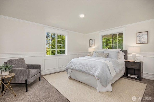 8021 NE Sandpiper Ln, Bainbridge Island, WA 98110 - bedroom featuring a decorative wall, crown molding, multiple windows, carpet, and wainscoting