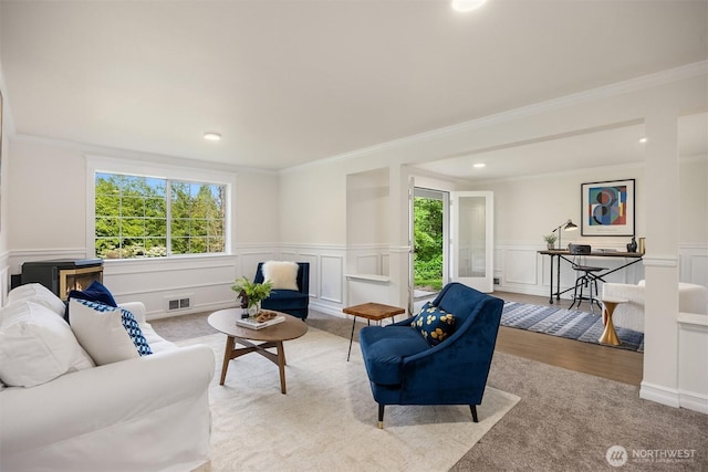 8021 NE Sandpiper Ln, Bainbridge Island, WA 98110 - living room featuring ornamental molding, a wainscoted wall, wood finished floors, a decorative wall, and recessed lighting