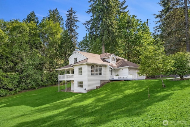 8021 NE Sandpiper Ln, Bainbridge Island, WA 98110 - rear view of house with a yard, a wooden deck, and a garage