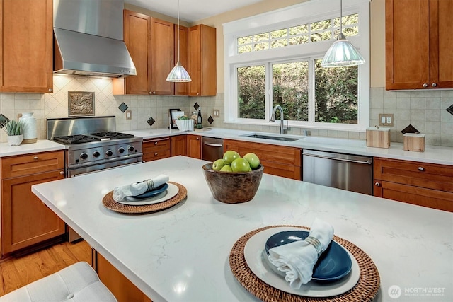 412 15th Ave, Kirkland, WA 98033 - kitchen featuring wall chimney exhaust hood, appliances with stainless steel finishes, a sink, and brown cabinets