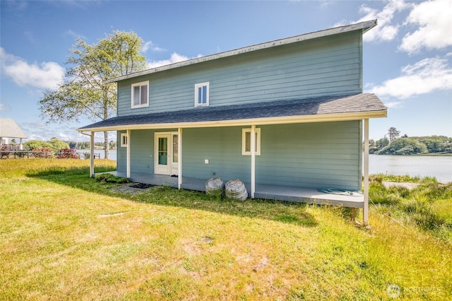 580 Mt Olympus Ave SE, Ocean Shores, WA 98569 - rear view of property with a lawn and a shingled roof