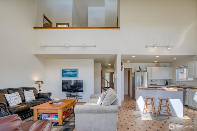 580 Mt Olympus Ave SE, Ocean Shores, WA 98569 - living area featuring a high ceiling and stairs