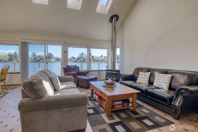 580 Mt Olympus Ave SE, Ocean Shores, WA 98569 - living room with a skylight, healthy amount of natural light, a water view, a wood stove, and high vaulted ceiling