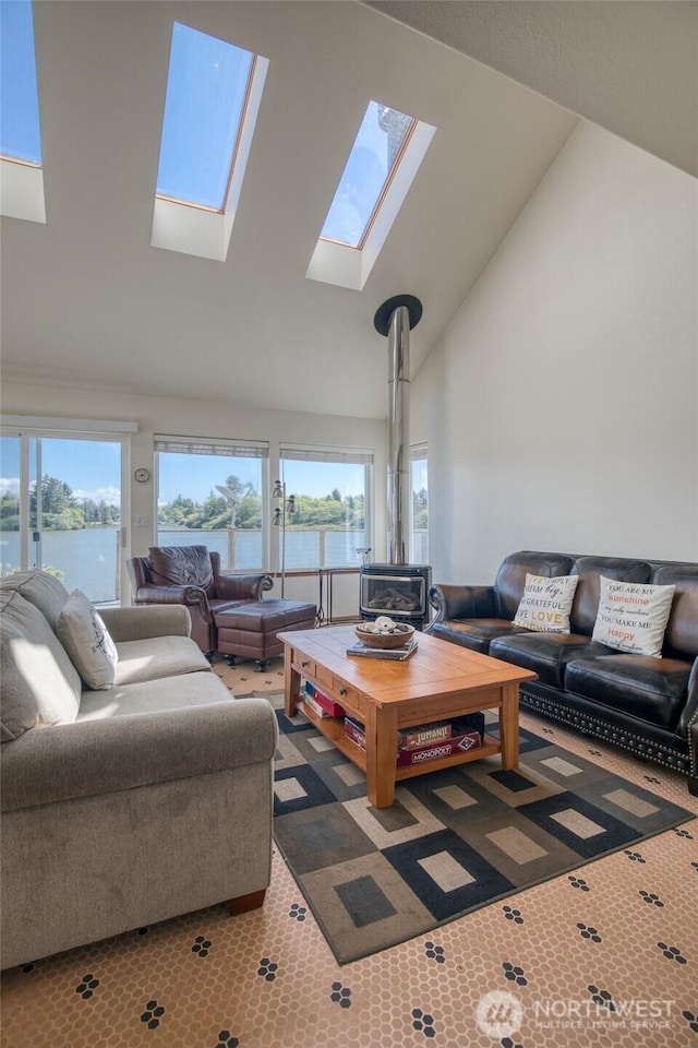 580 Mt Olympus Ave SE, Ocean Shores, WA 98569 - living room with a skylight, high vaulted ceiling, a wood stove, and a water view