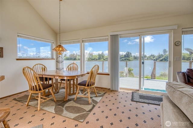 580 Mt Olympus Ave SE, Ocean Shores, WA 98569 - dining space featuring plenty of natural light, vaulted ceiling, a water view, and carpet floors