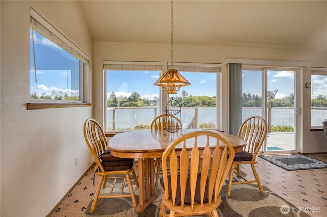 580 Mt Olympus Ave SE, Ocean Shores, WA 98569 - dining space featuring a water view, baseboards, a chandelier, and vaulted ceiling