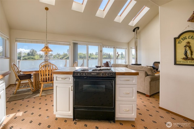 580 Mt Olympus Ave SE, Ocean Shores, WA 98569 - kitchen featuring black range with electric cooktop, tile countertops, a skylight, white cabinets, and plenty of natural light