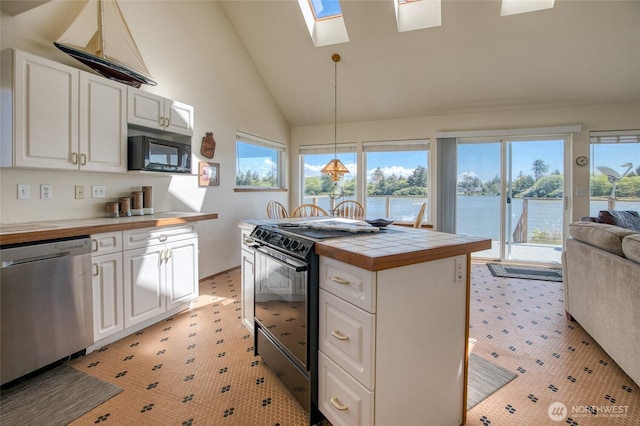 580 Mt Olympus Ave SE, Ocean Shores, WA 98569 - kitchen featuring black appliances, white cabinets, open floor plan, and high vaulted ceiling