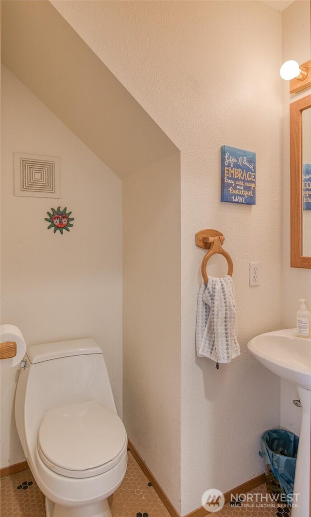 580 Mt Olympus Ave SE, Ocean Shores, WA 98569 - bathroom featuring toilet, baseboards, and tile patterned flooring