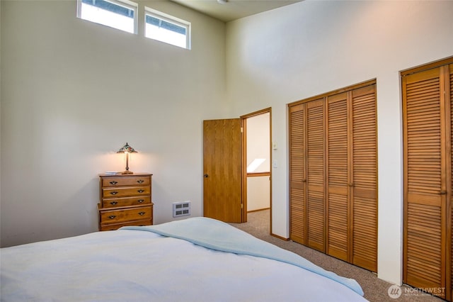 580 Mt Olympus Ave SE, Ocean Shores, WA 98569 - carpeted bedroom with multiple closets and a high ceiling