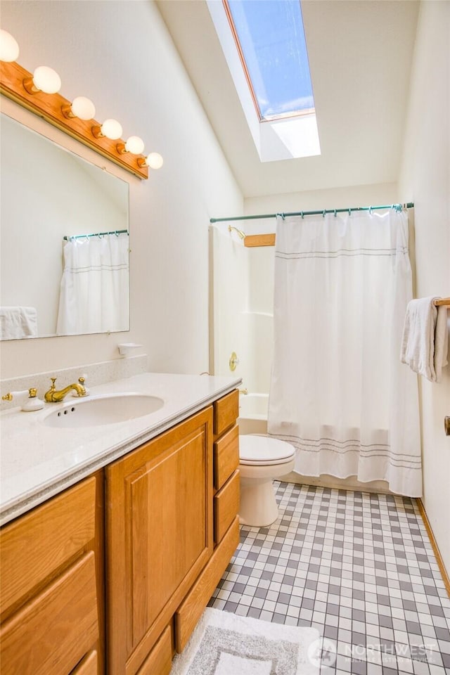580 Mt Olympus Ave SE, Ocean Shores, WA 98569 - bathroom with a skylight, vanity, lofted ceiling, toilet, and shower / tub combo with curtain