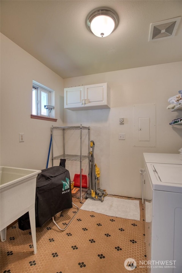 580 Mt Olympus Ave SE, Ocean Shores, WA 98569 - laundry room featuring washing machine and clothes dryer, cabinet space, and electric panel