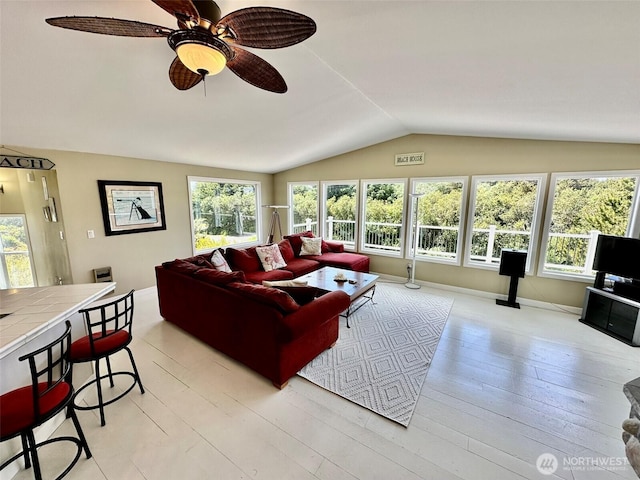 530 Sand Dune Ave SW, Ocean Shores, WA 98569 - living area with vaulted ceiling, ceiling fan, and light wood-style flooring