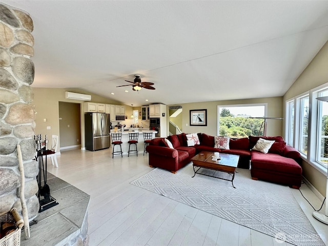 530 Sand Dune Ave SW, Ocean Shores, WA 98569 - living room featuring vaulted ceiling, plenty of natural light, light wood finished floors, and a wall mounted air conditioner