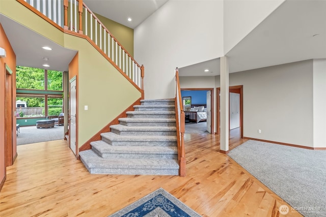 2616 171st Ave E, Lake Tapps, WA 98391 - stairs featuring wood finished floors, a high ceiling, baseboards, and recessed lighting