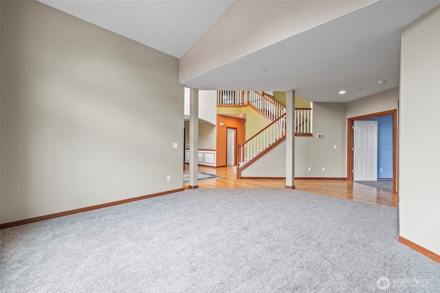 2616 171st Ave E, Lake Tapps, WA 98391 - unfurnished living room with carpet, baseboards, stairway, and lofted ceiling