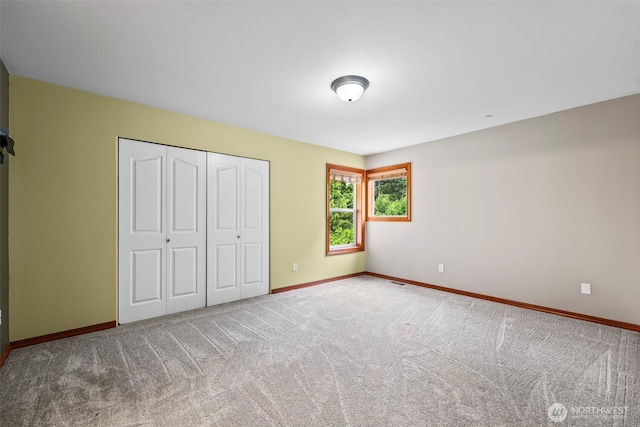2616 171st Ave E, Lake Tapps, WA 98391 - unfurnished bedroom featuring carpet, baseboards, and a closet