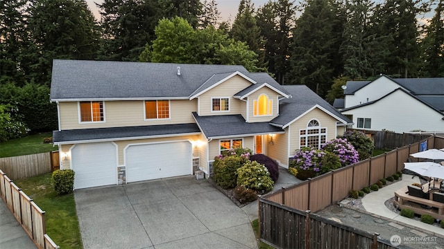 2616 171st Ave E, Lake Tapps, WA 98391 - traditional-style home with concrete driveway, a garage, roof with shingles, and a fenced backyard