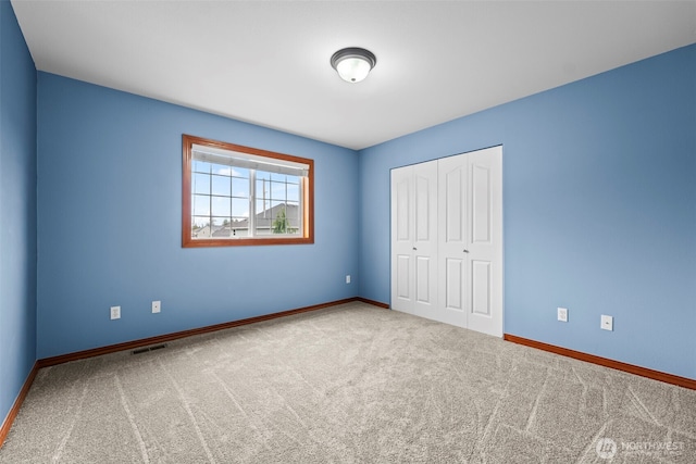 2616 171st Ave E, Lake Tapps, WA 98391 - unfurnished bedroom featuring carpet flooring, baseboards, and a closet