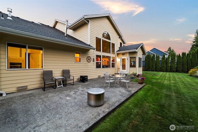 2616 171st Ave E, Lake Tapps, WA 98391 - back of house at dusk with a patio area and a lawn