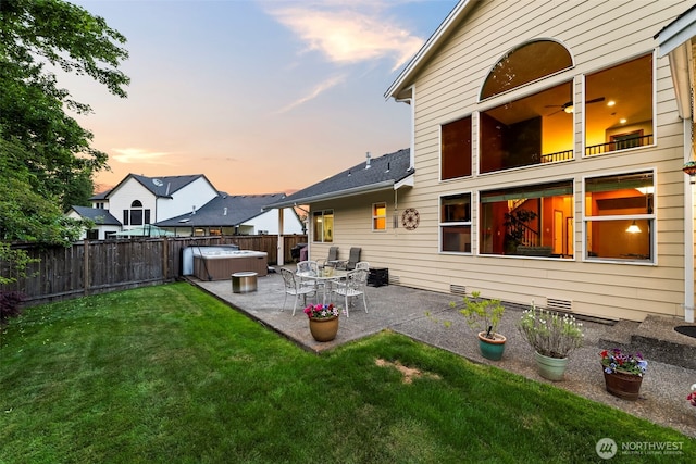 2616 171st Ave E, Lake Tapps, WA 98391 - back of house at dusk featuring a hot tub, a patio area, and crawl space