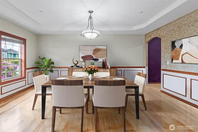 2616 171st Ave E, Lake Tapps, WA 98391 - dining room featuring a tray ceiling, wainscoting, light wood finished floors, and a decorative wall