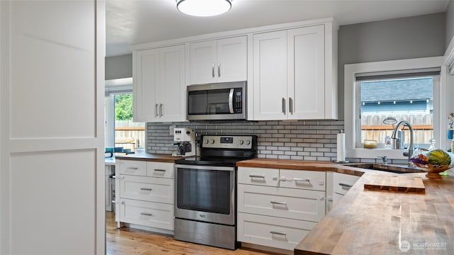 1109 University St, Walla Walla, WA 99362 - kitchen featuring butcher block countertops, stainless steel appliances, a sink, and backsplash