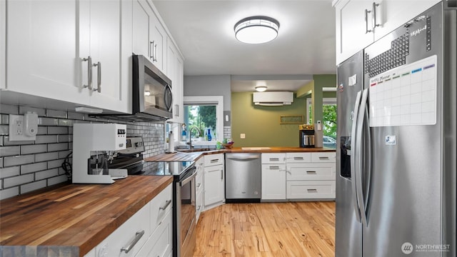 1109 University St, Walla Walla, WA 99362 - kitchen featuring butcher block countertops, appliances with stainless steel finishes, a sink, and tasteful backsplash