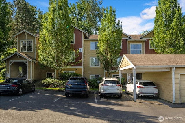 710 240th Way SE Unit J302, Sammamish, WA 98074 - view of front of home with uncovered parking, board and batten siding, and a shingled roof