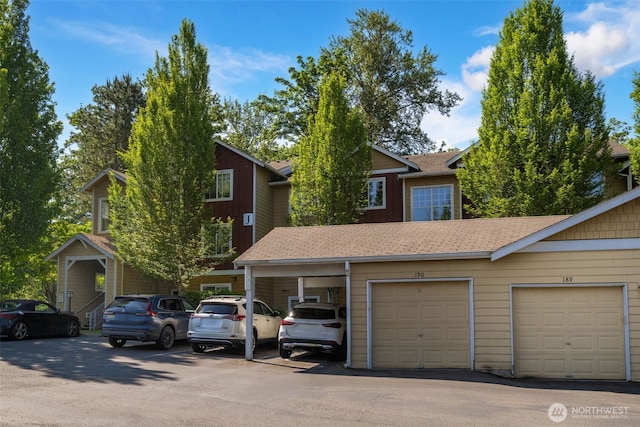 710 240th Way SE Unit J302, Sammamish, WA 98074 - view of front of house featuring community garages and roof with shingles