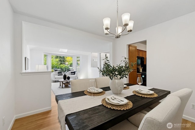 1826 168th Pl SE, Mill Creek, WA 98012 - dining space with a chandelier, light wood-style flooring, and baseboards