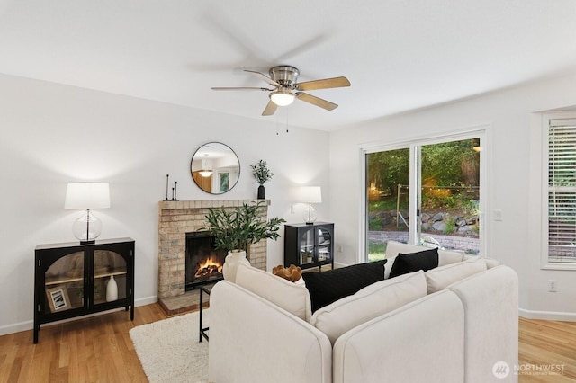 1826 168th Pl SE, Mill Creek, WA 98012 - living area with ceiling fan, wood finished floors, a fireplace, and baseboards