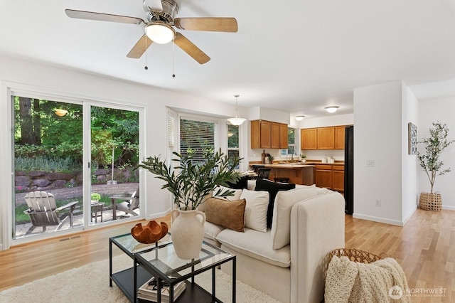 1826 168th Pl SE, Mill Creek, WA 98012 - living room featuring light wood-style floors, baseboards, and ceiling fan