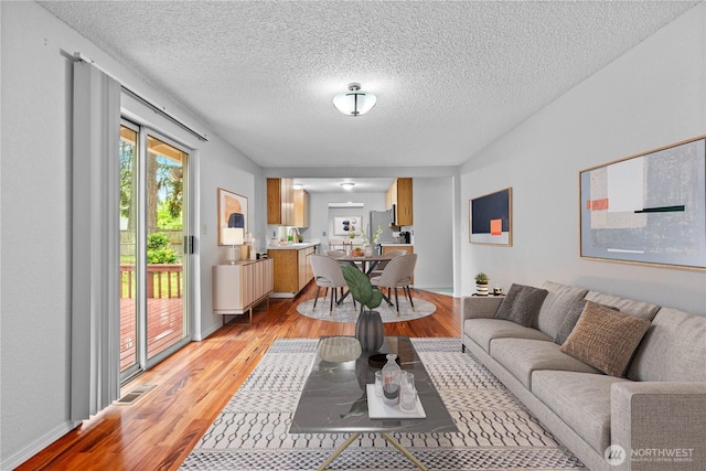 18802 10th Avenue Ct E, Tacoma, WA 98387 - living area with light wood-type flooring and a textured ceiling