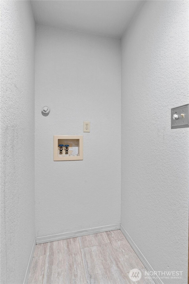 18802 10th Avenue Ct E, Tacoma, WA 98387 - washroom featuring hookup for a washing machine, wood finished floors, and baseboards