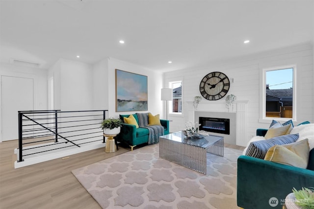 8042 19th Ave NW, Seattle, WA 98117 - living area featuring wood finished floors, recessed lighting, and a glass covered fireplace