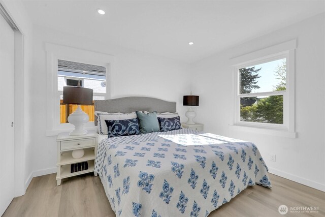 8042 19th Ave NW, Seattle, WA 98117 - bedroom featuring wood finished floors, multiple windows, baseboards, and recessed lighting