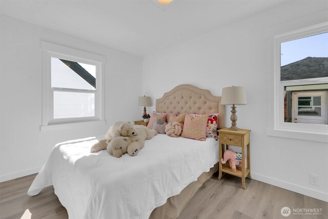 8042 19th Ave NW, Seattle, WA 98117 - bedroom with wood finished floors, multiple windows, and baseboards