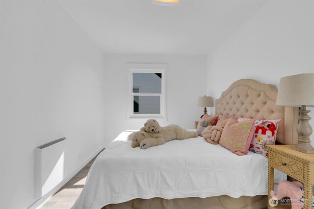 8042 19th Ave NW, Seattle, WA 98117 - bedroom featuring wood finished floors, baseboards, and radiator heating unit