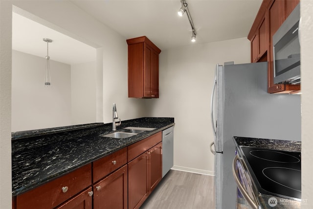 512 141st Ave SE Unit 55, Bellevue, WA 98007 - kitchen with appliances with stainless steel finishes, a sink, light wood-type flooring, dark stone countertops, and decorative light fixtures