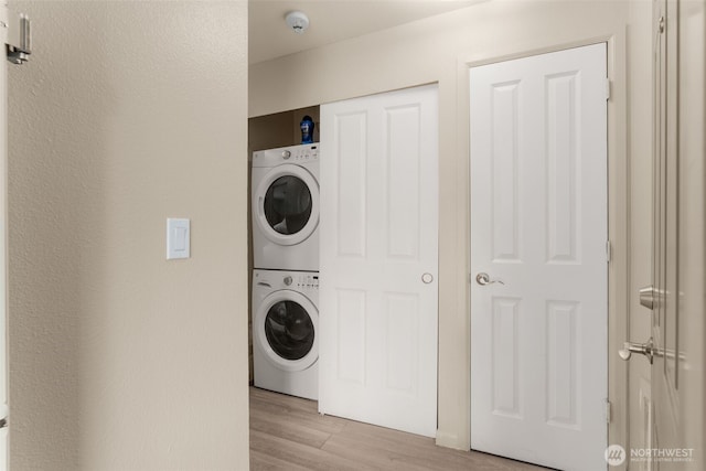 512 141st Ave SE Unit 55, Bellevue, WA 98007 - laundry room featuring stacked washer and clothes dryer and light wood finished floors