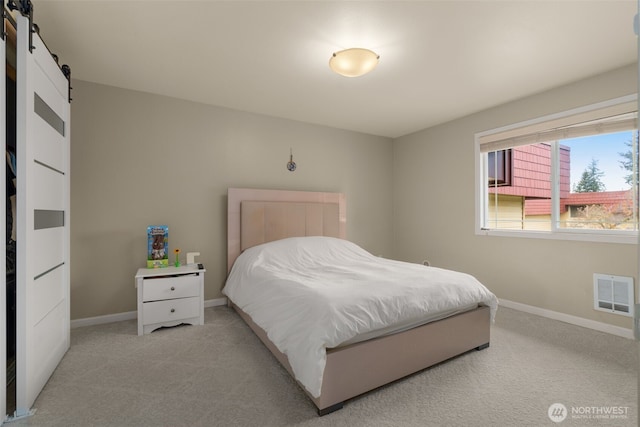 512 141st Ave SE Unit 55, Bellevue, WA 98007 - bedroom with a barn door, light carpet, and baseboards
