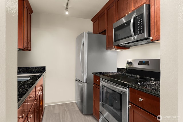 512 141st Ave SE Unit 55, Bellevue, WA 98007 - kitchen with stainless steel appliances, light wood-type flooring, dark stone countertops, rail lighting, and a sink