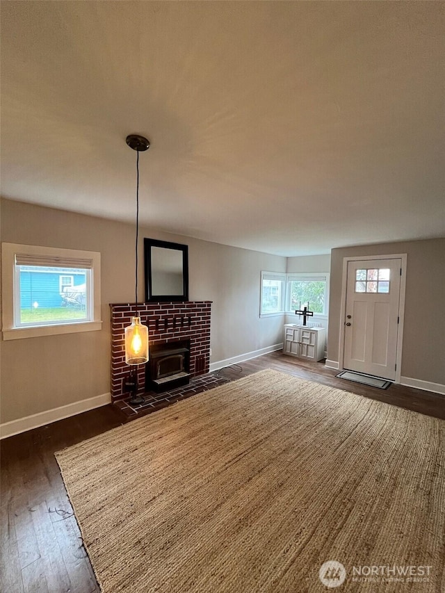 908 Washington Ave N, Long Beach, WA 98631 - unfurnished living room featuring dark wood finished floors and a wood stove