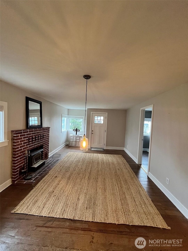 908 Washington Ave N, Long Beach, WA 98631 - unfurnished living room featuring a wood stove and dark wood finished floors